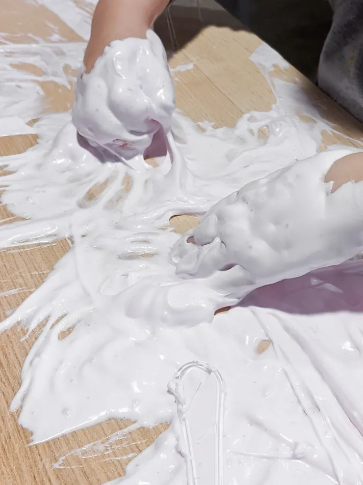 mixing glue water and shaving cream to make DIY fluffy slime