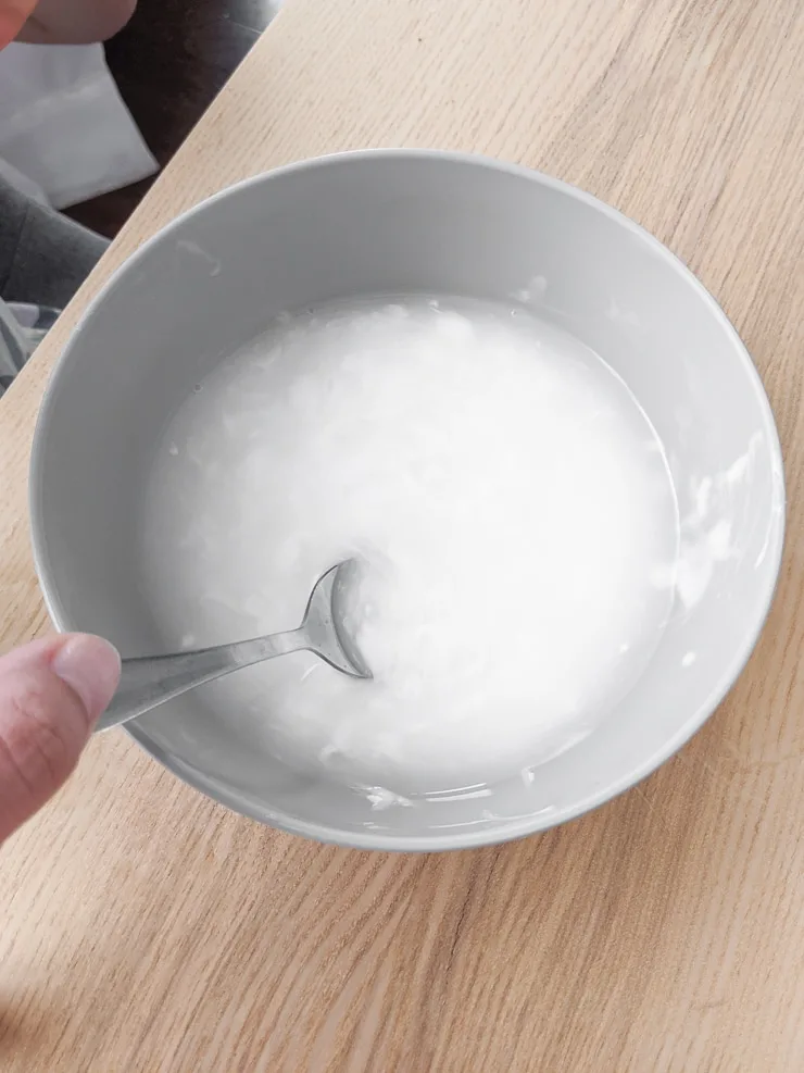 mixing glue and water in a bowl to make easy DIY slime