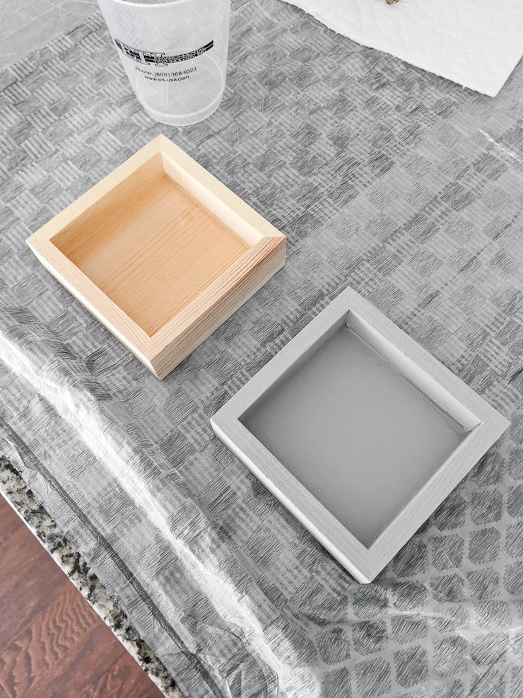 adding resin to small wooden trays