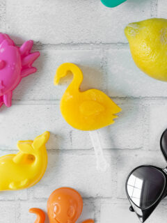 homemade orange juice popsicle made in a flamingo mold