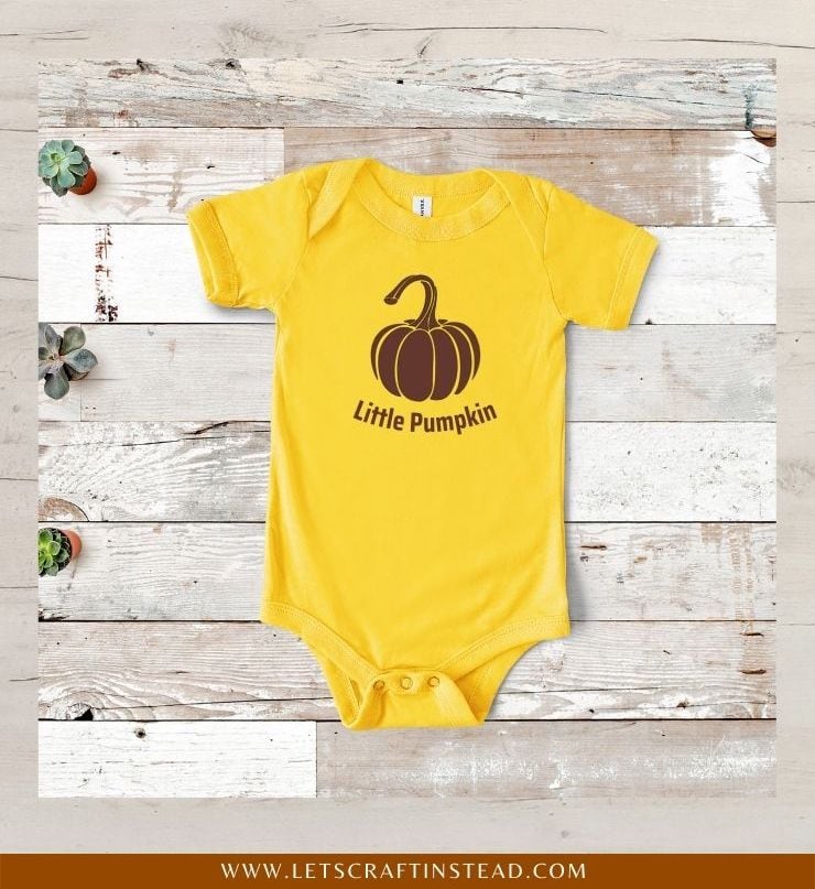 image of a pumpkin SVG file mocked up on a yellow baby bodysuit