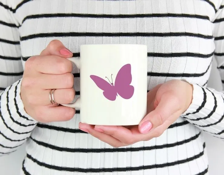 free simple butterfly cut file mocked up on a coffee cup