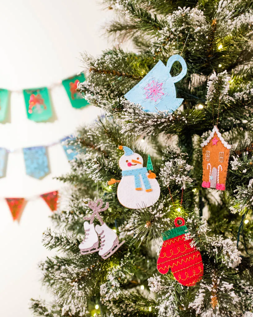 snowman, mitten teacup felt ornaments on a Christmas tree