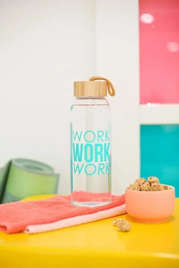 Clear water bottle with work work work text