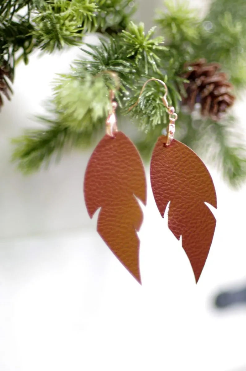feather shaped leather earrings made with Cricut 