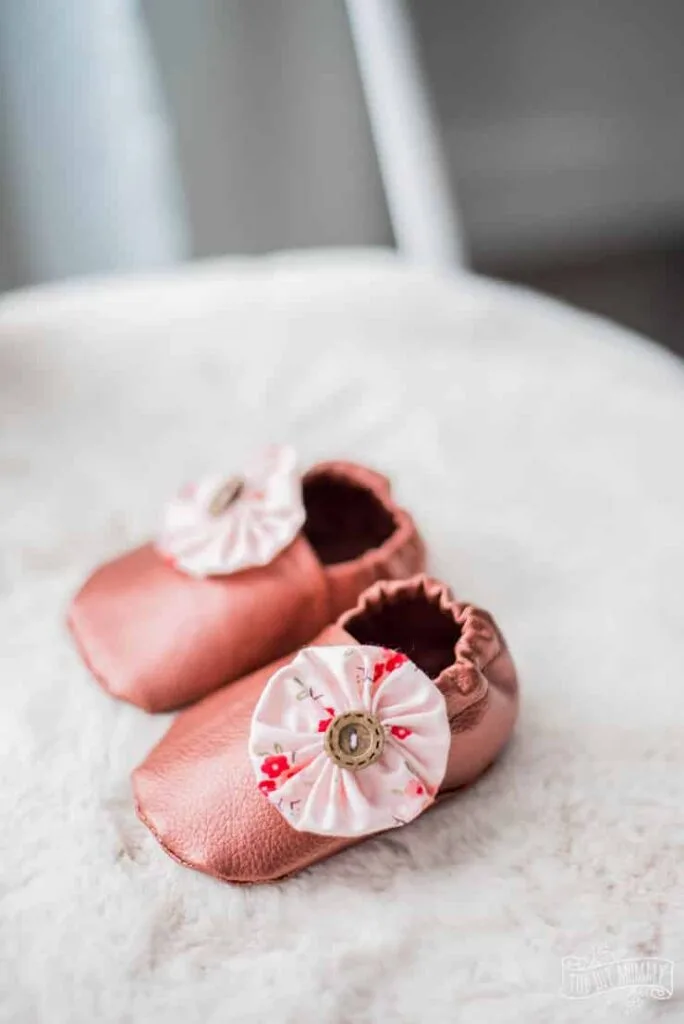 pink leather baby slippers made using a Cricut