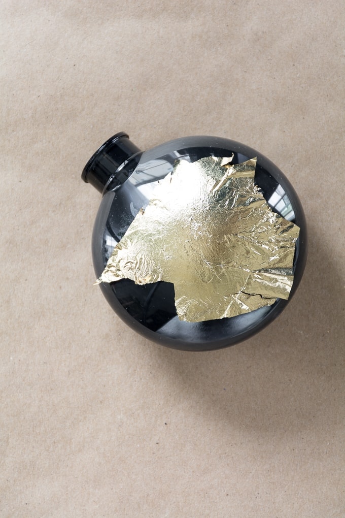 applying gold foil to ornament