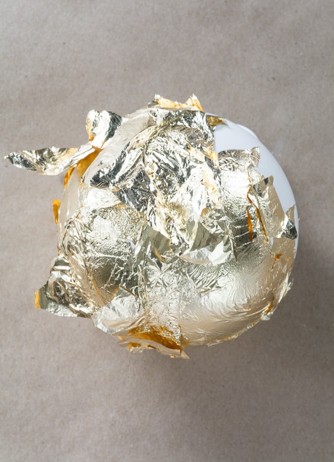 applying gold foil to ornament