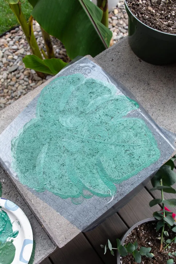 painting the plant leaf vinyl stencil using acrylic green paint