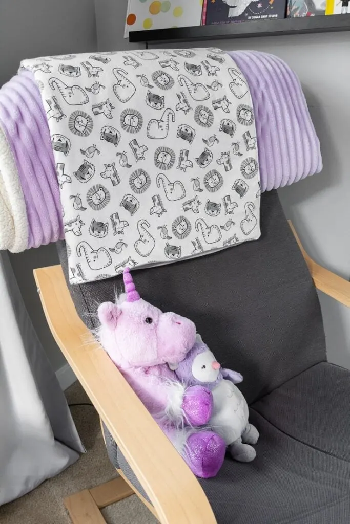 easy double-sided baby blanket sewing project on a rocking chair with stuffed animals
