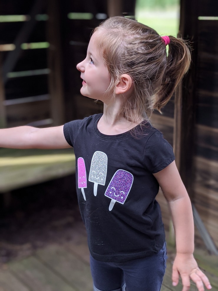 little girl with a shirt that has iron0on popsicles on it