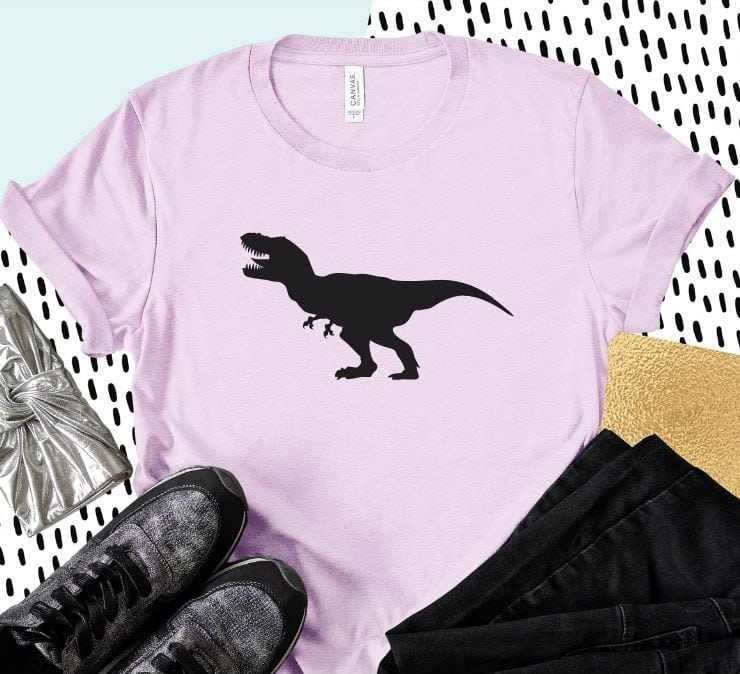 pink shirt with a t-rex on it