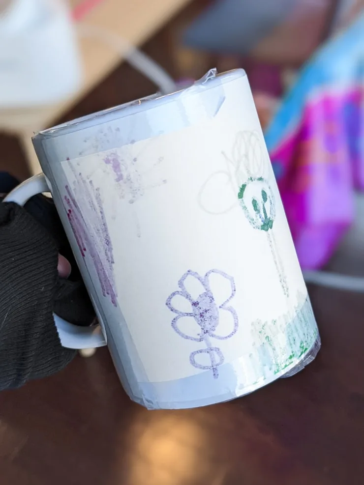 taping a design onto a Cricut mug blank