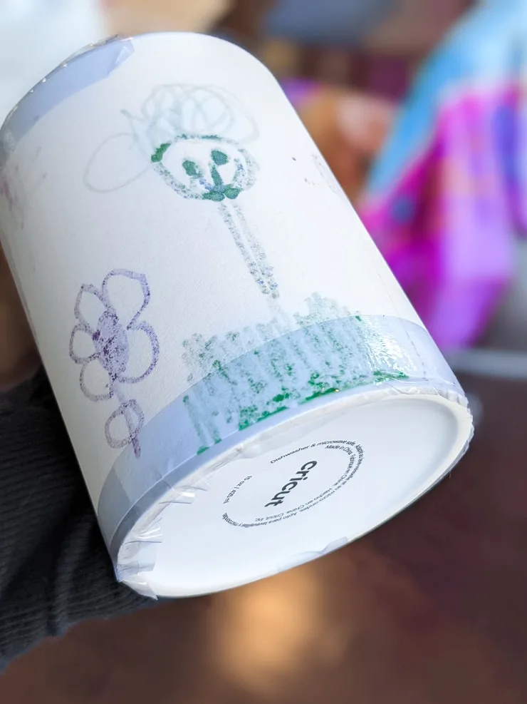 taping a design onto a Cricut mug blank