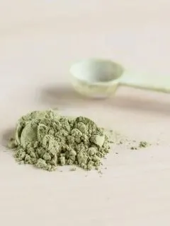 matcha powder next to a measuring spoon