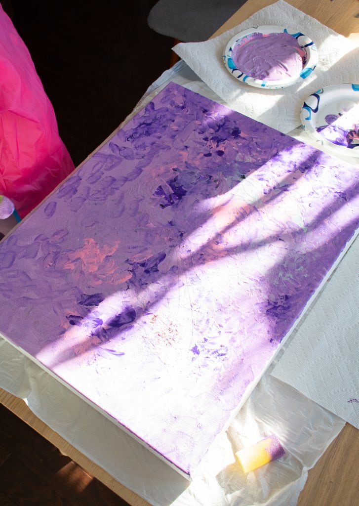 using acrylic paints to paint an abstract kids art piece
