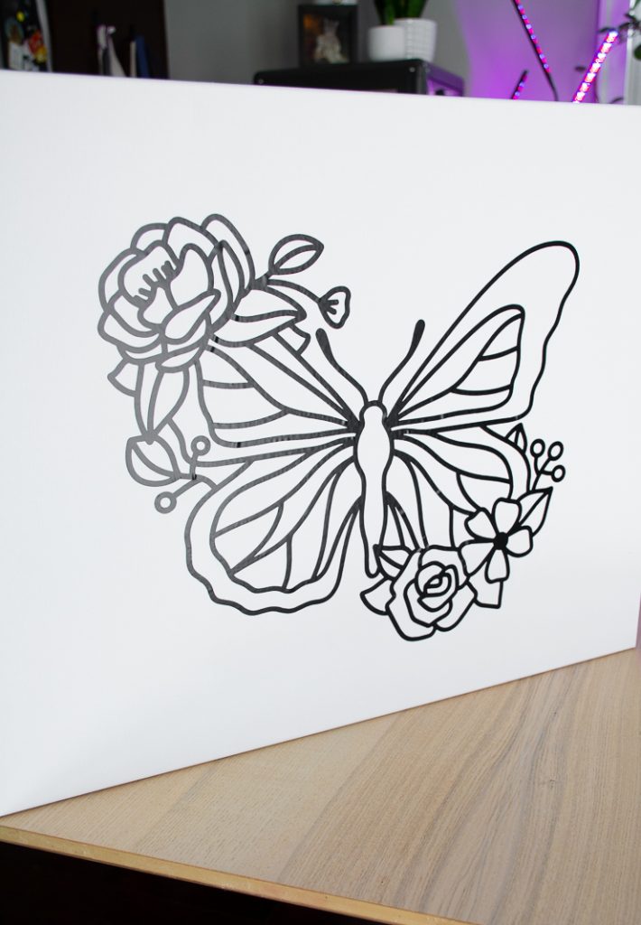 vinyl butterfly stencil on a blank canvas