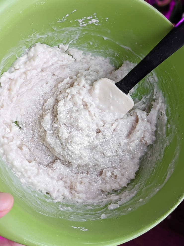 mixing homemade playdough ingredients and glitter in a bowl
