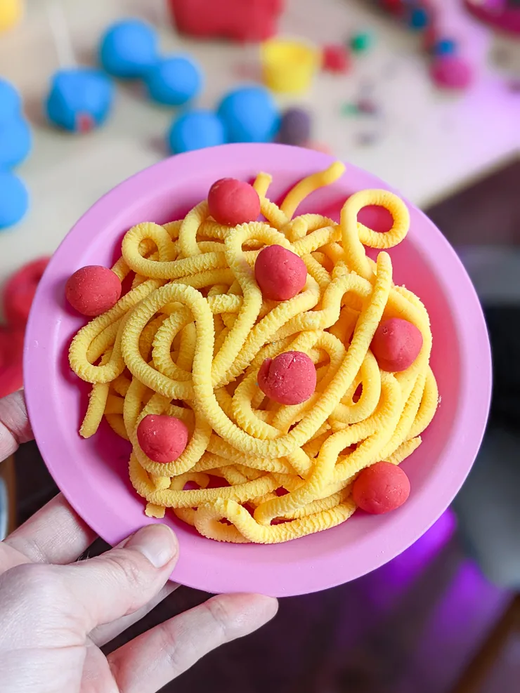 fake noodles and meatballs made of playdough
