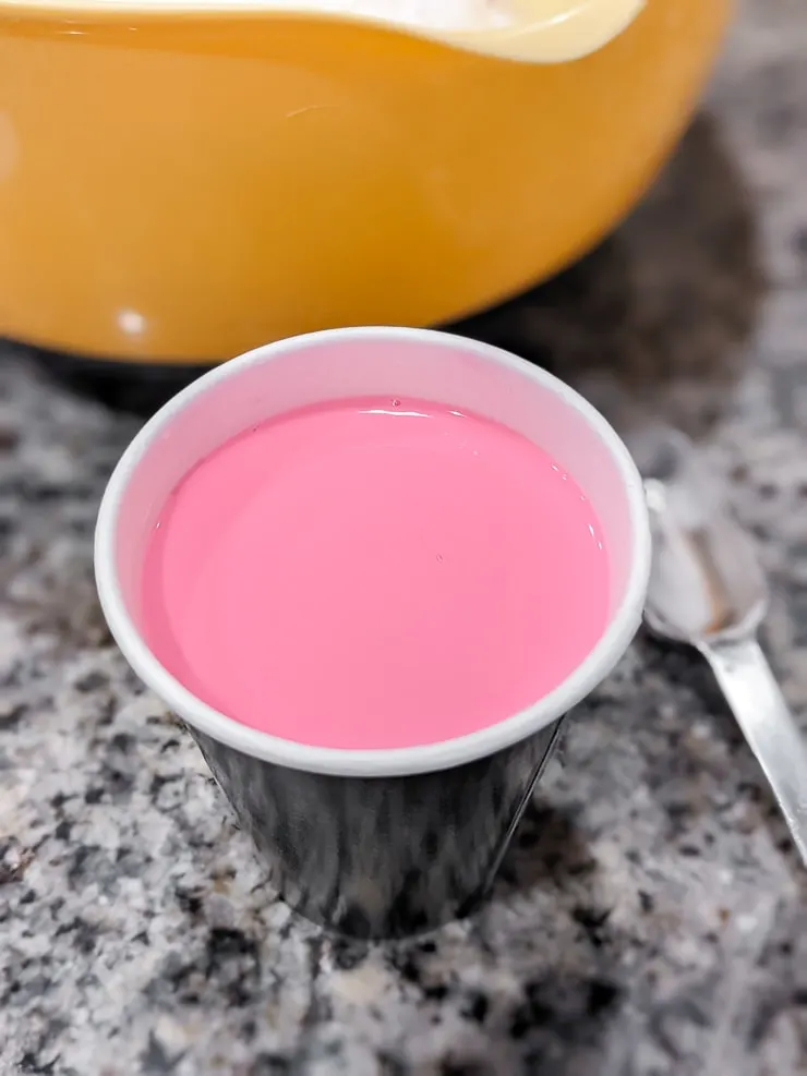 pink mixture in a paper cup