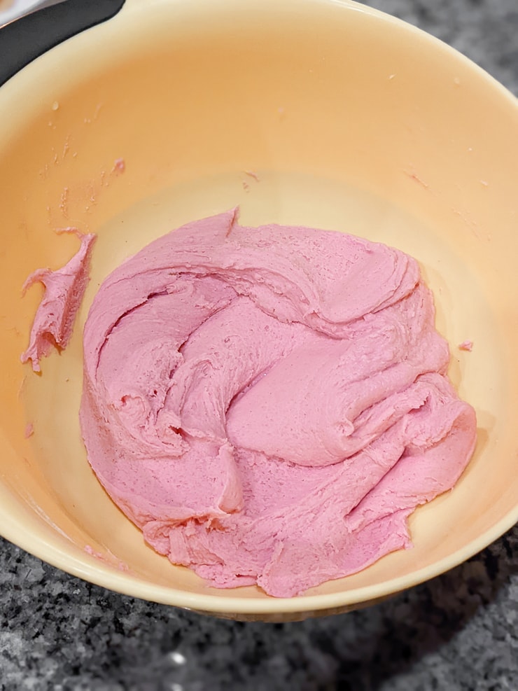 mixing pink playdough ingredients in a mixing bowl