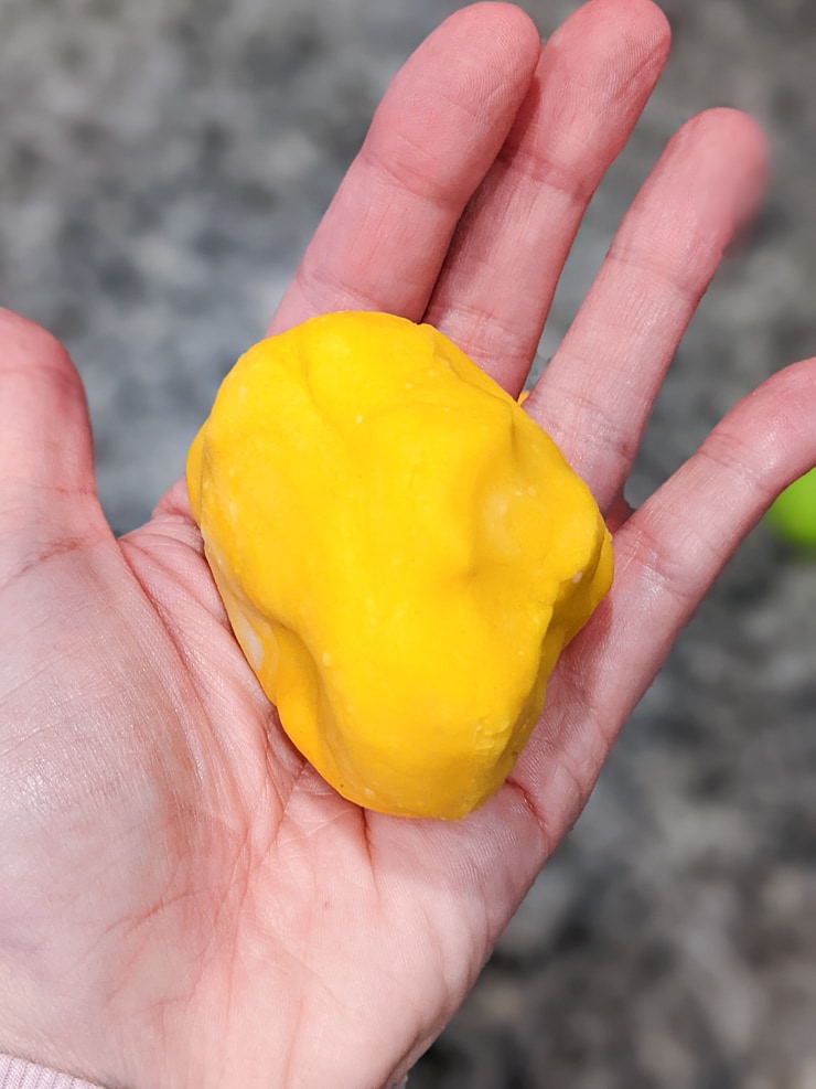 homemade playdough with yellow food coloring mixed in