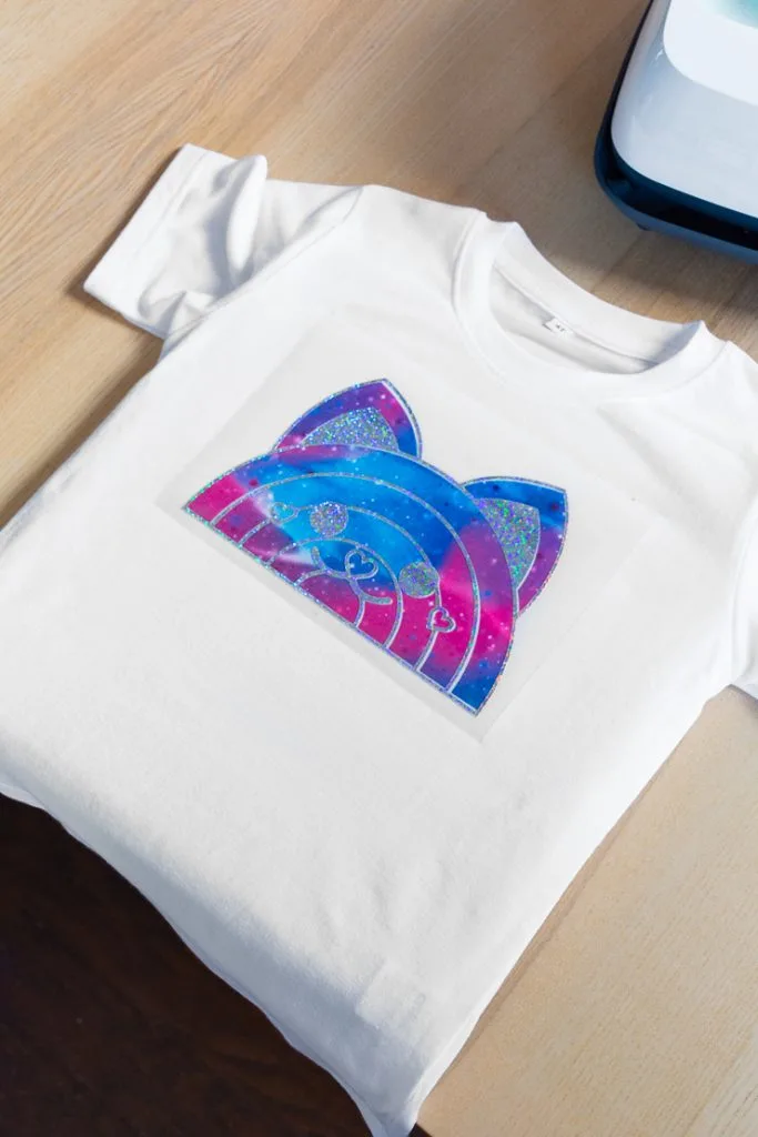 purple and blue rainbow cat design on a shirt