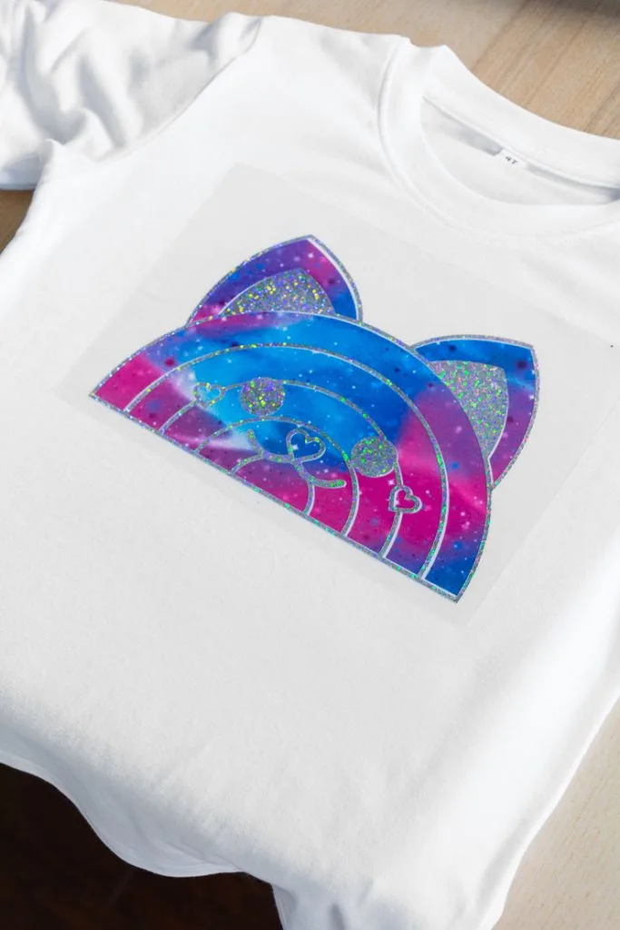 purple and blue rainbow cat design on a shirt