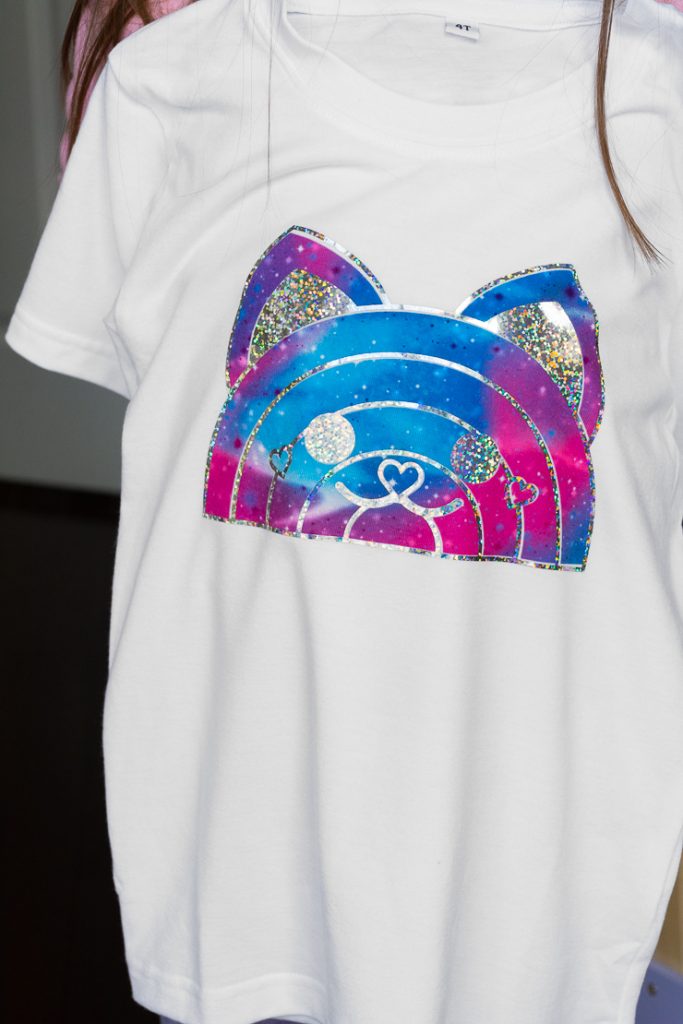 purple, blue, and holographic glitter cat design on a shirt