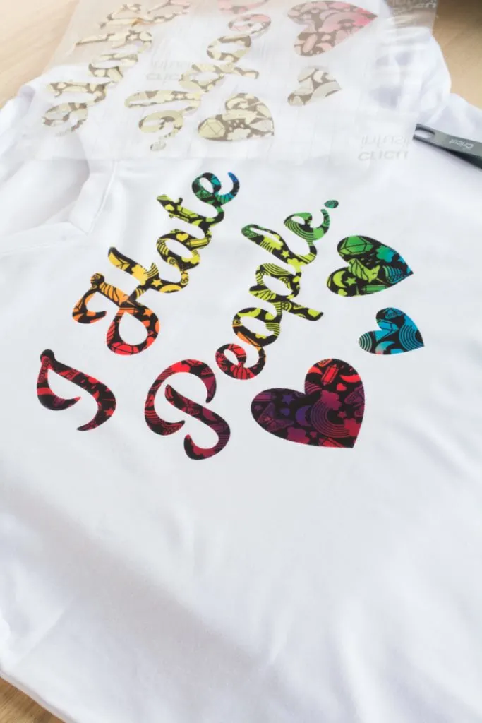 white shirt that says I Hate People in rainbow fonts