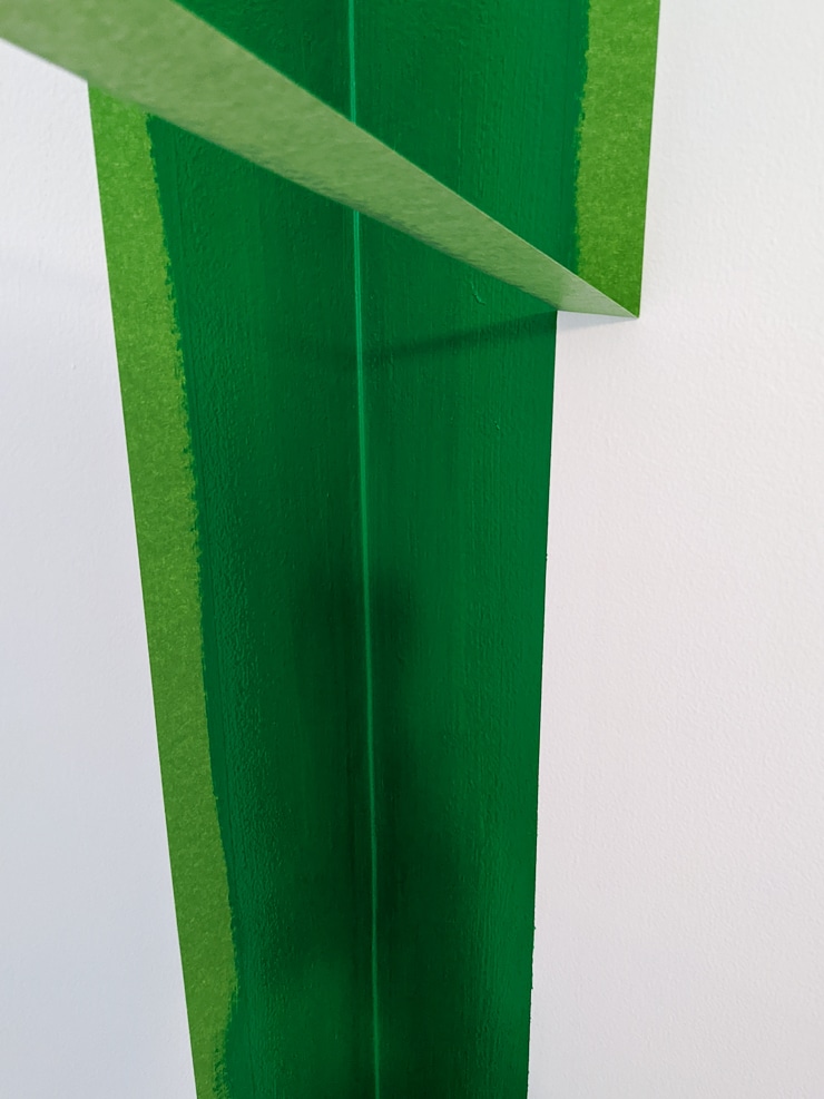 removing frogtape from a green-painted wall