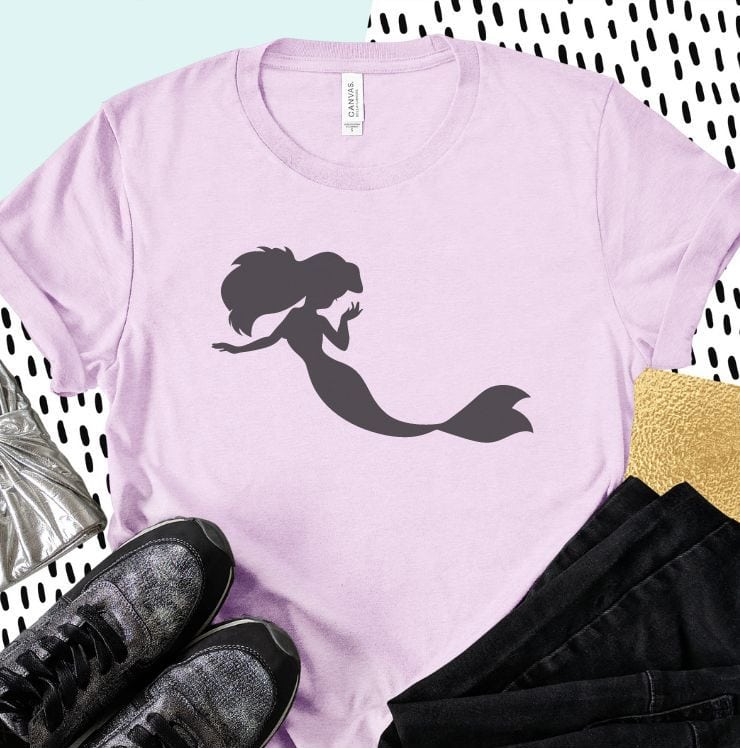 purple shirt flat lay with a gray mermaid on it