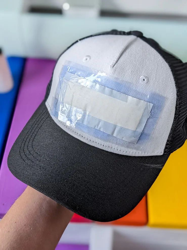 decal taped onto a cricut hat black