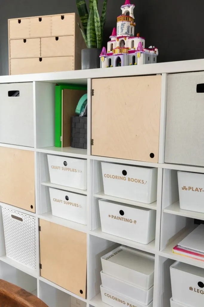 Ikea storage unit with labeled boxes on it