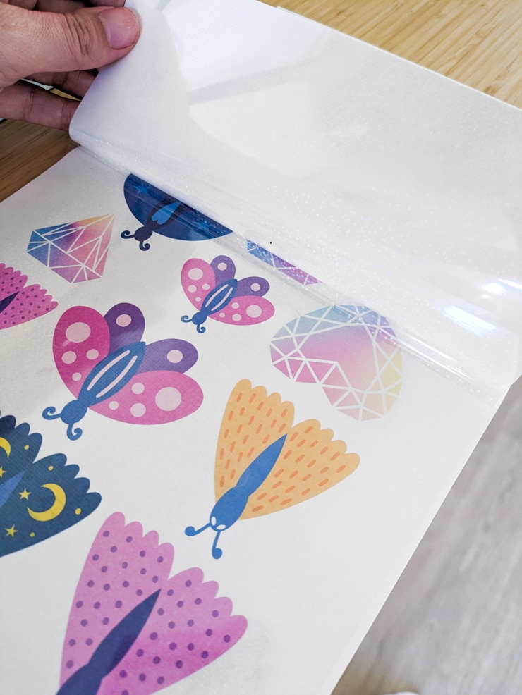 applying the holographic overlay sheet to make stickers on a cricut