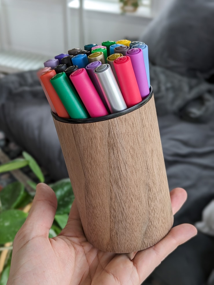 tin can upcycled into a pencil holder with wood veneer
