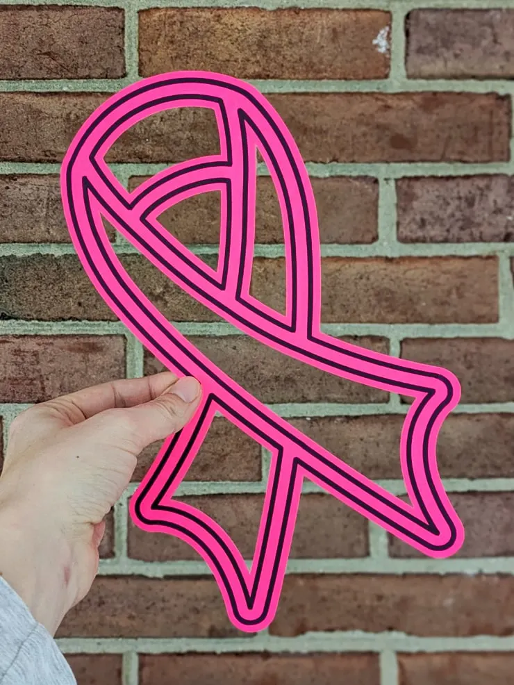 pink breast cancer ribbon cut from paper